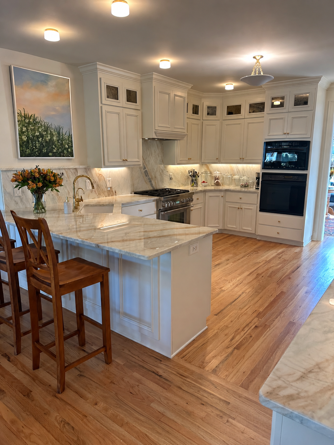 White kitchen with full-height inset cabinetry, paneled range hood, marble backsplash, and island